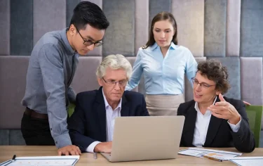 Business professionals reviewing international factoring invoices and export documents